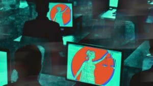 Na zdjęciu widać komputery i monitory, na których wyświetlane są motywy sprawiedliwość, zdalna praca