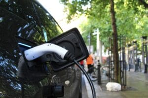 Zdjęcie przedstawia samochód elektryczny podczas ładowania